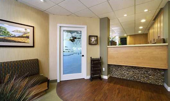 The waiting room of Cruz Orthodontics. The front desk and door to the back office is visible.