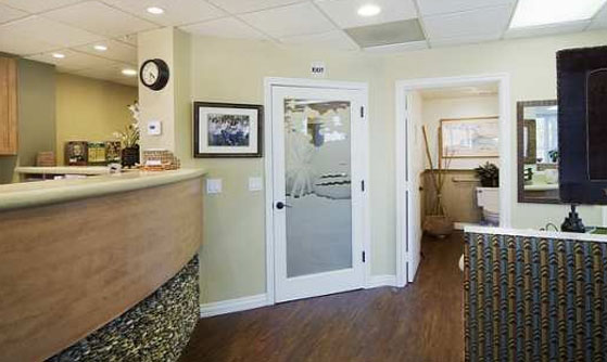 The waiting room of Cruz Orthodontics. The exit and restroom are visible.